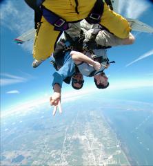 Several skydivers in upside down free fall.