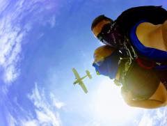 Skydiver looking up at the plane they just jumped out of.