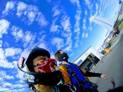 Skydivers walk to their plane.