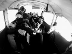 A group of skydivers in the plane cabin.