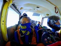 A group of skydivers inside the plane.