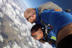 Skydiving above the clouds.