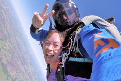 An excited woman free falling at 120 miles per hour.