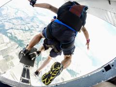 Tandem jumpers leap out of the plane.