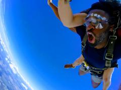 A man enjoying the free fall before his parachute opens.