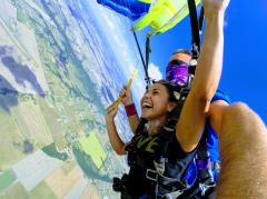 Tandem jumpers make their final turn to the landing zone.