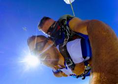 Tandem skydivers on a bright sunny day.