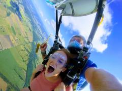 An excited woman skydiving over Texas.