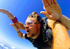 A young man skydiving with arms out.