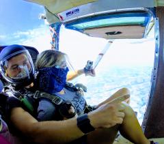 Tandem jumpers looking out the cabin door.