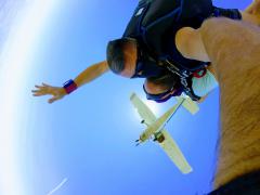 Skydivers with plane overhead.