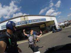 A women poses on the ground at Dallas Skydive Center.