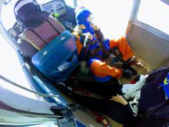 A tandem jumper looks out the cabin door.