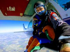 Tandem jumpers sitting at the cabin door.