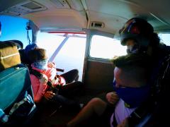 Skydiver looks out the cabin door.