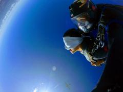 A women skydives with a blindfold.